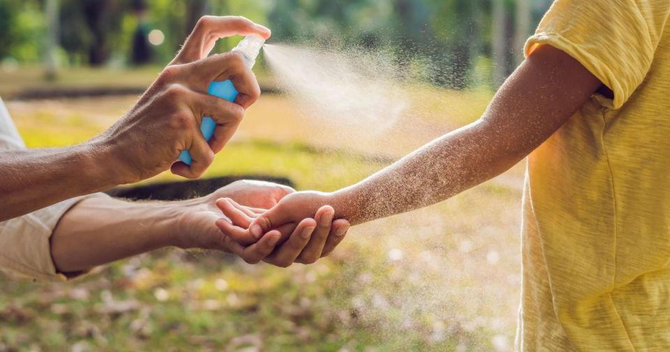 Pest control myths for parents debunked: what you need to know for safe home protection Parent spraying natural bug repellent on child outdoors to debunk pest control myths and ensure safe home protection for an article titled pest control myths for parents debunked: what you need to know for safe home protection