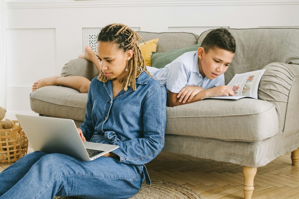 10 digital tools every busy parent needs in 2025 Mom and son are on their laptops for an article about 10 digital tools every busy parent needs in 2025