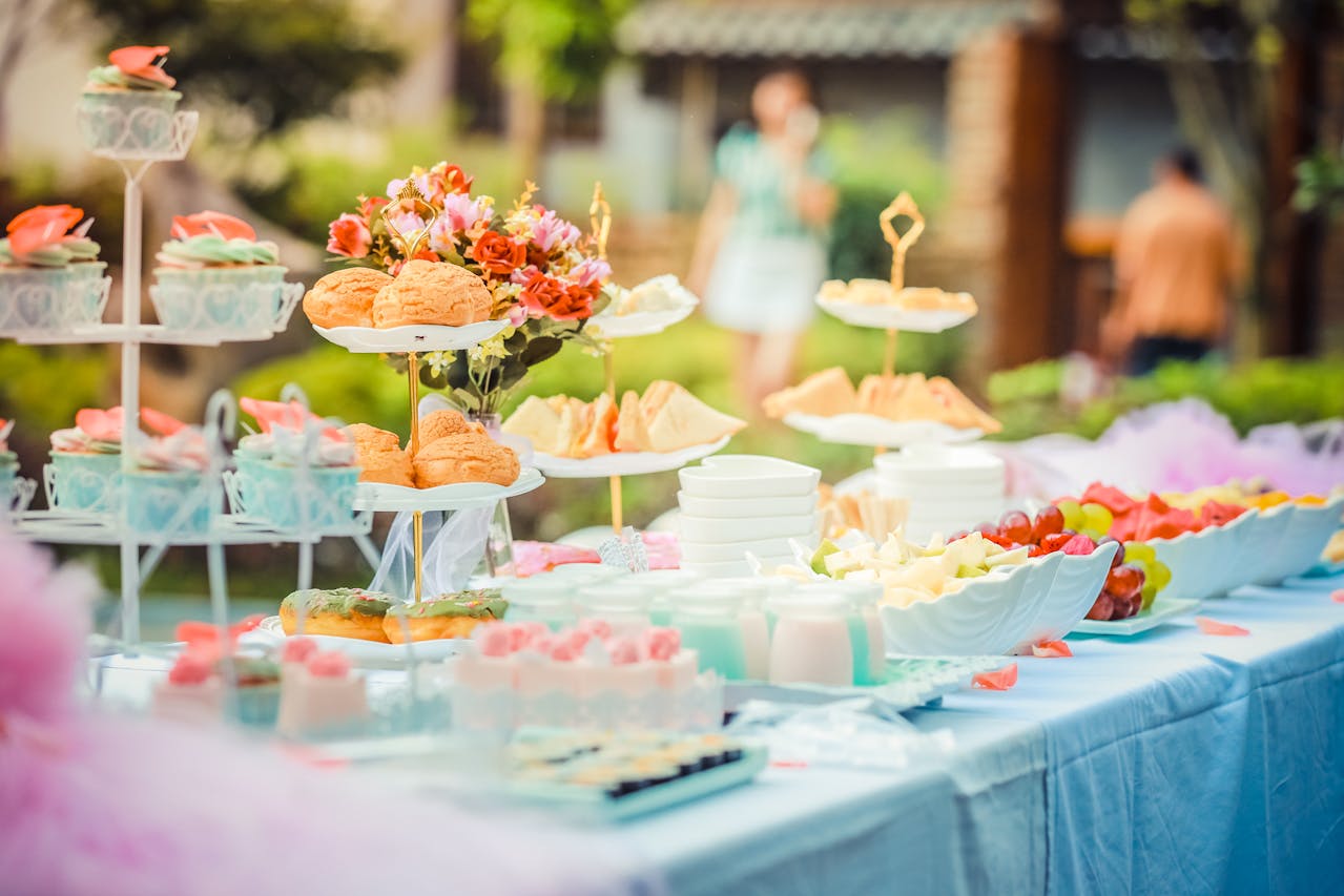 How to plan a baby shower that supports new parents in their journey A tablescape of food for a baby shower for an article about how to plan a baby shower that supports new parents in their journey.