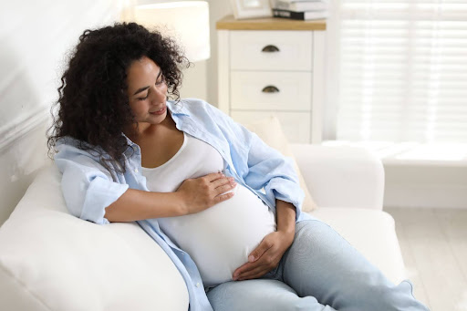 Can you get dermal fillers while pregnant? Are lip fillers safe during pregnancy, pregnant woman resting at home, safe beauty options while expecting