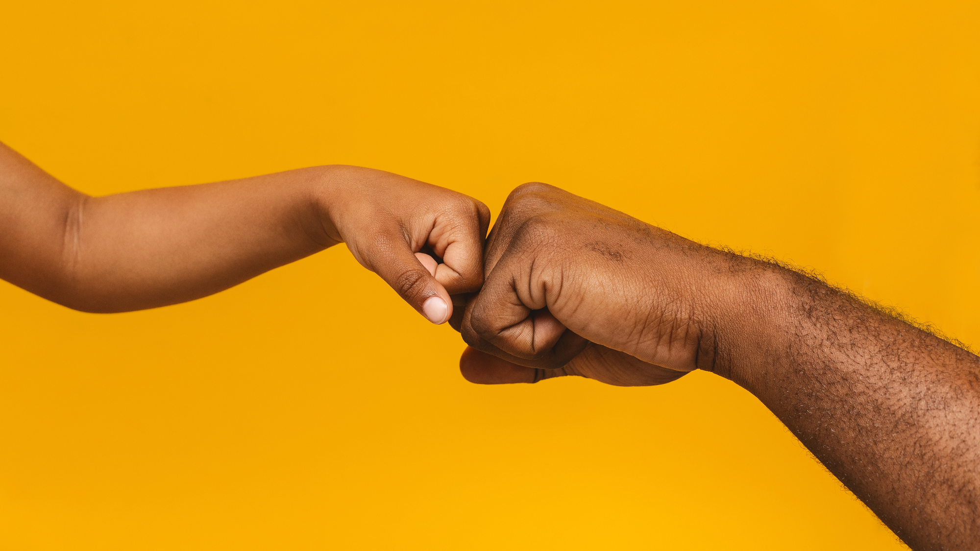 5 ways to discuss mental health with your children An african american child and father bump fists for an article titled, "5 ways to discuss mental health with your children"
