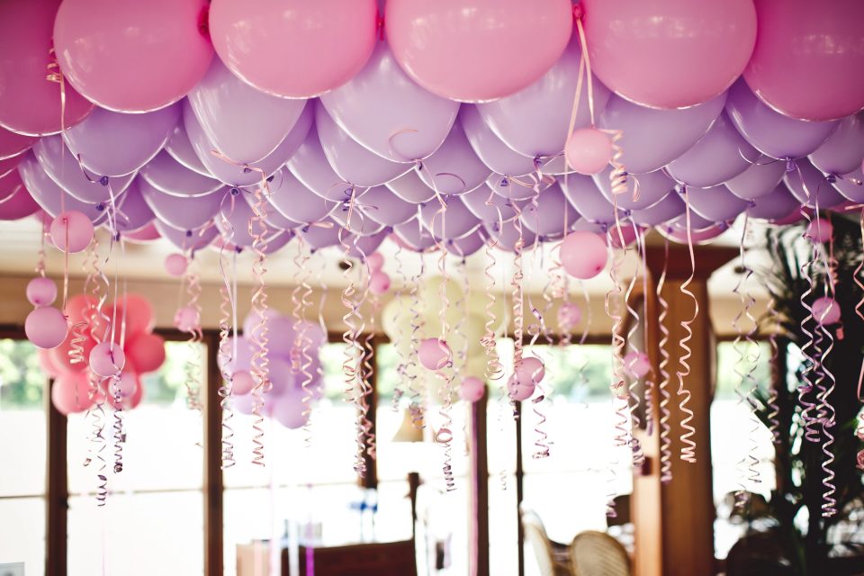 Why tuftex balloons are a top choice for event decorators Pink and purple tuftex balloons with ribbons used in elegant event decor