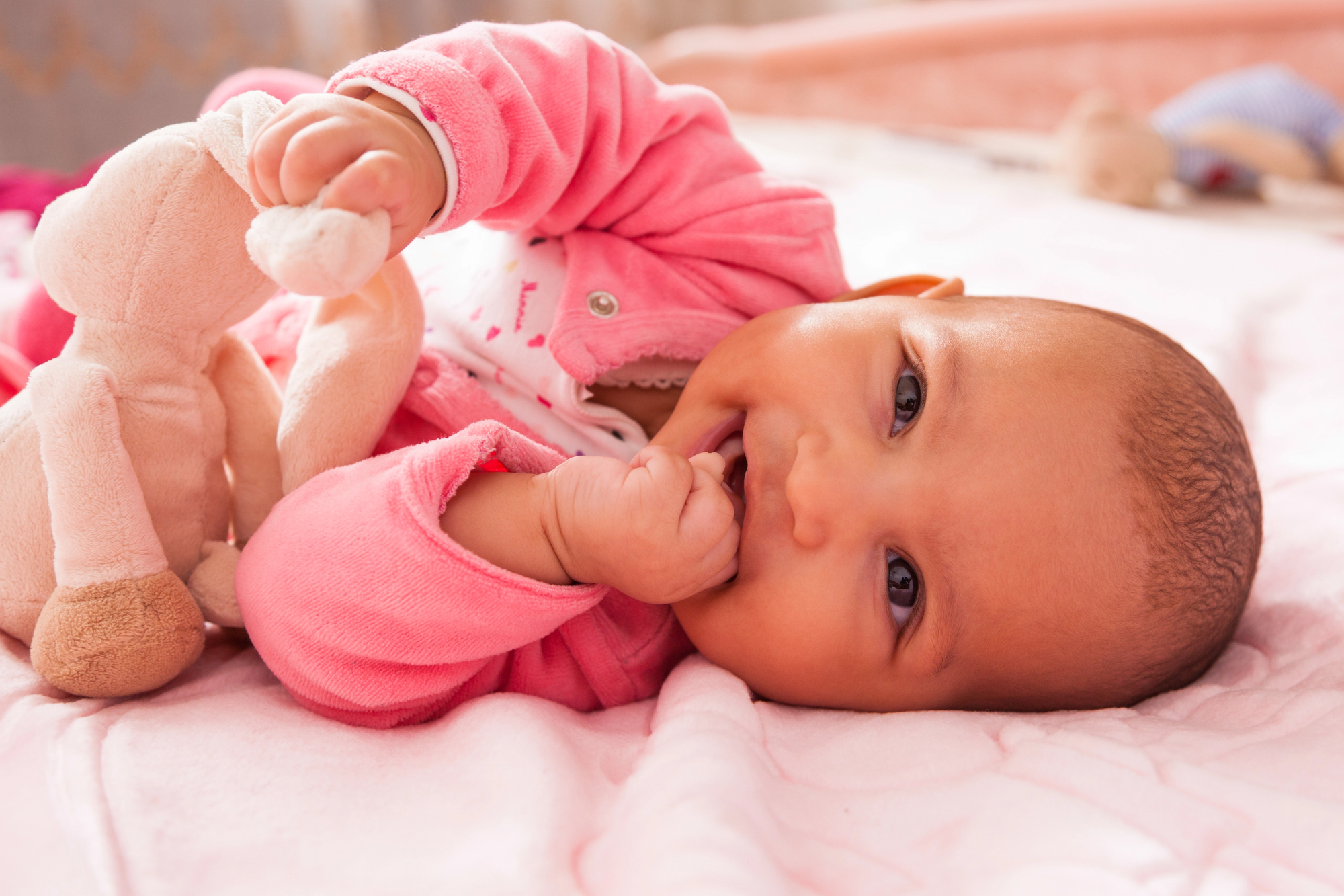 Find the perfect baby name and essential gear for new parents An african american newborn girl baby on a bed in pink find the perfect baby name and essential gear for new parents