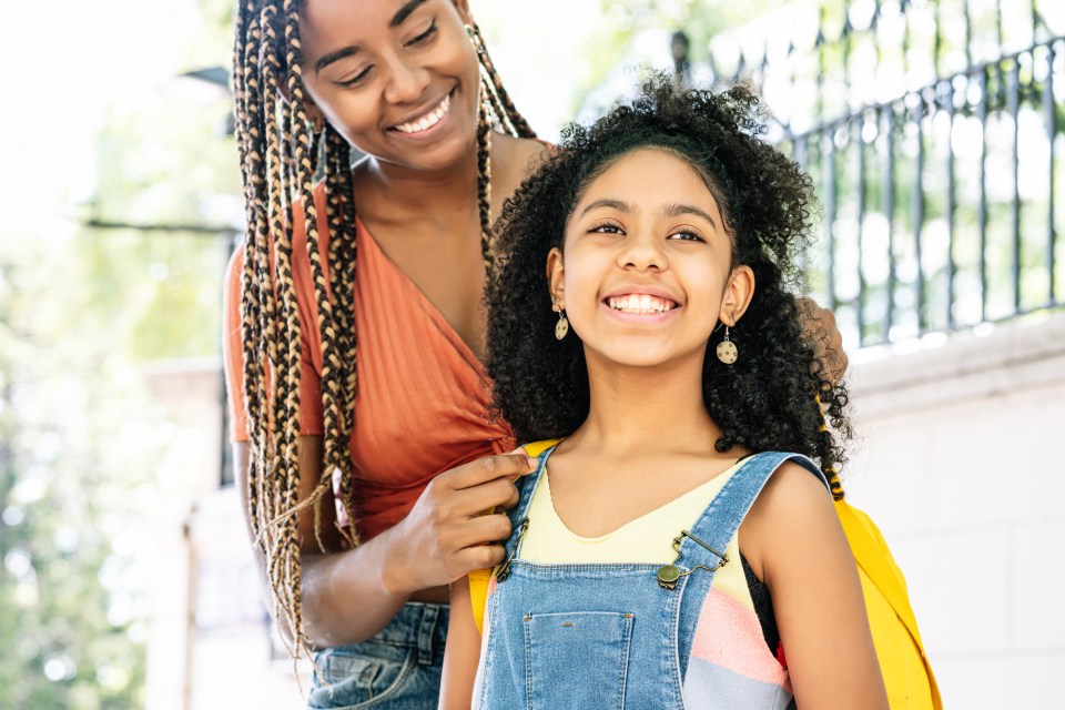 The power of black parents and teachers in education A black parent takes her child to school  to experience the power of black parents and teachers in education