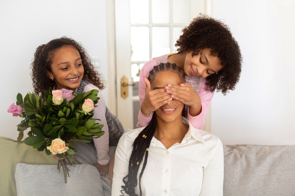 Mother's day roses: the complete guide to choosing perfect blooms Daughters surprise their mom with roses for an article about mother's day roses: the complete guide to choosing perfect blooms