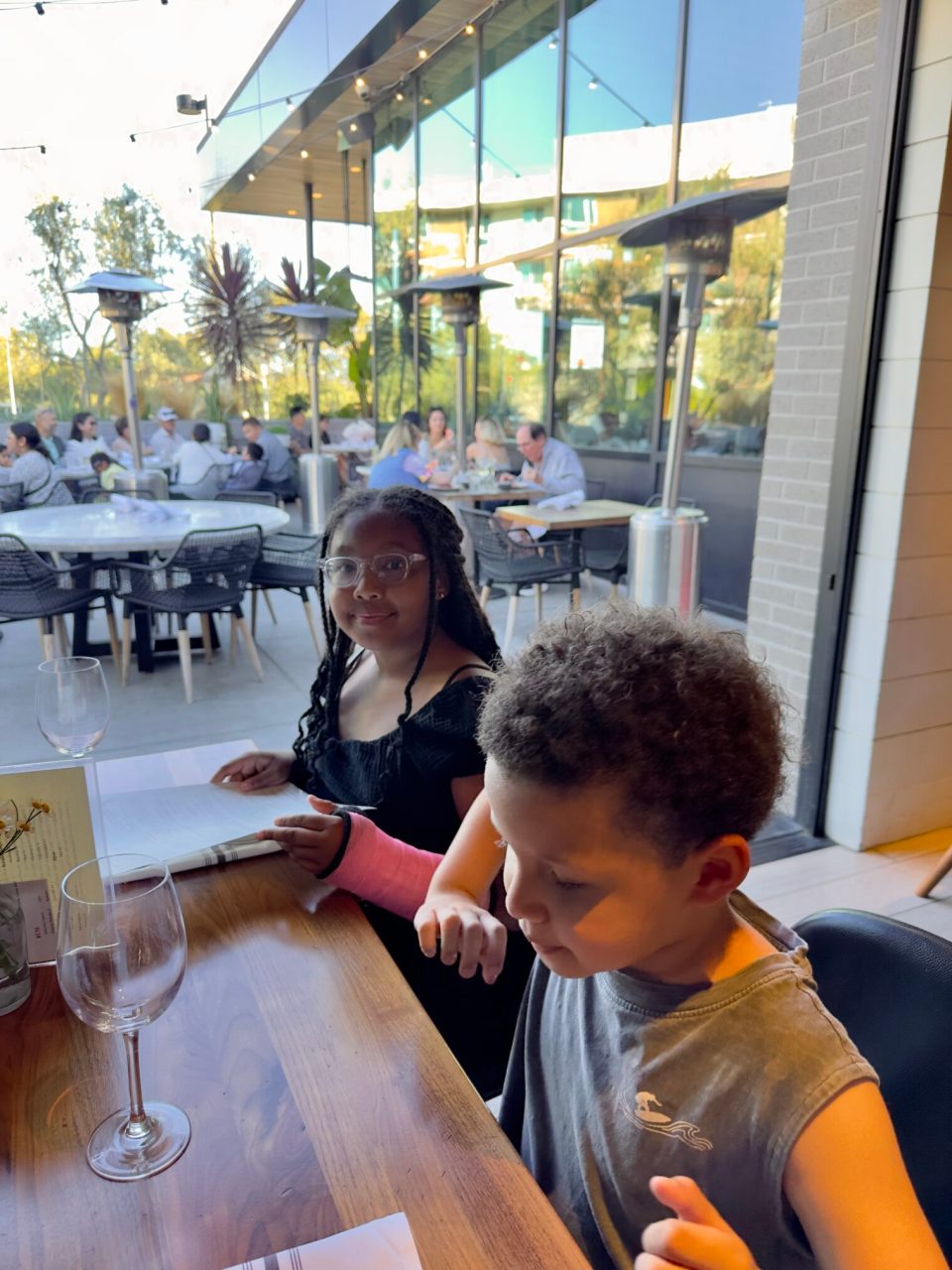 Irvine, california: a family-friendly option with plenty to experience and a few lessons learned Dinner at north italia in irvine with a young black girl with braids and a pink cast on her arm and a young boy.