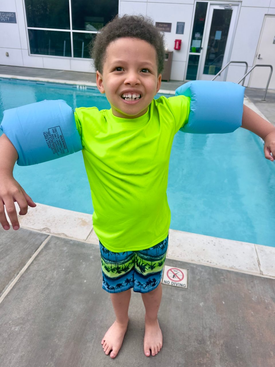 Irvine, california: a family-friendly option with plenty to experience and a few lessons learned A young black boy with floaties on his arms at the swimming pool at the hyatt house in irvine, california.