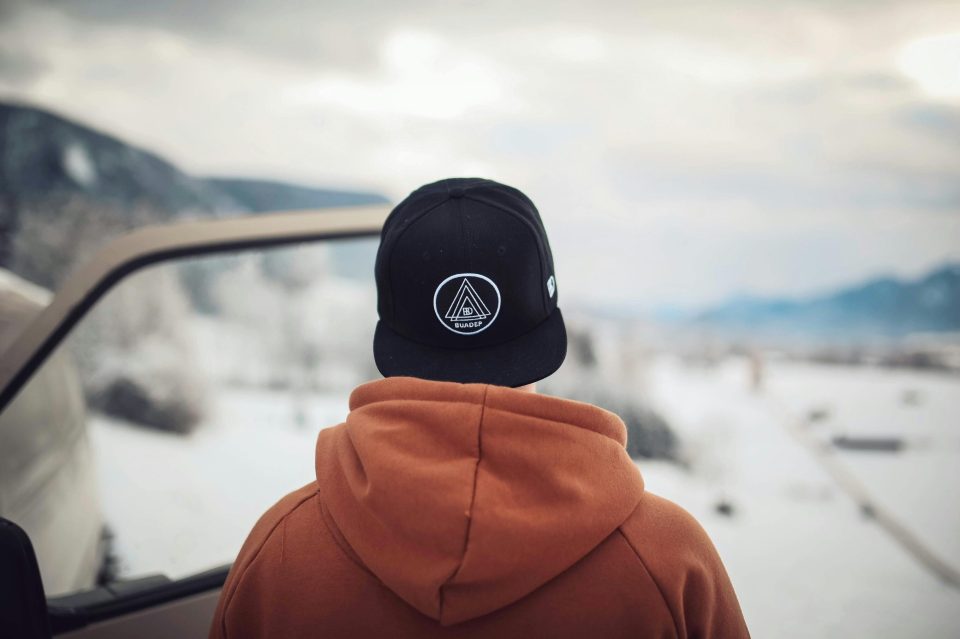 Hoodie designs for every season: tips for year-round styling for teens A teenager stares at the landscape wearing a hoodie for an article about hoodie designs for black teens