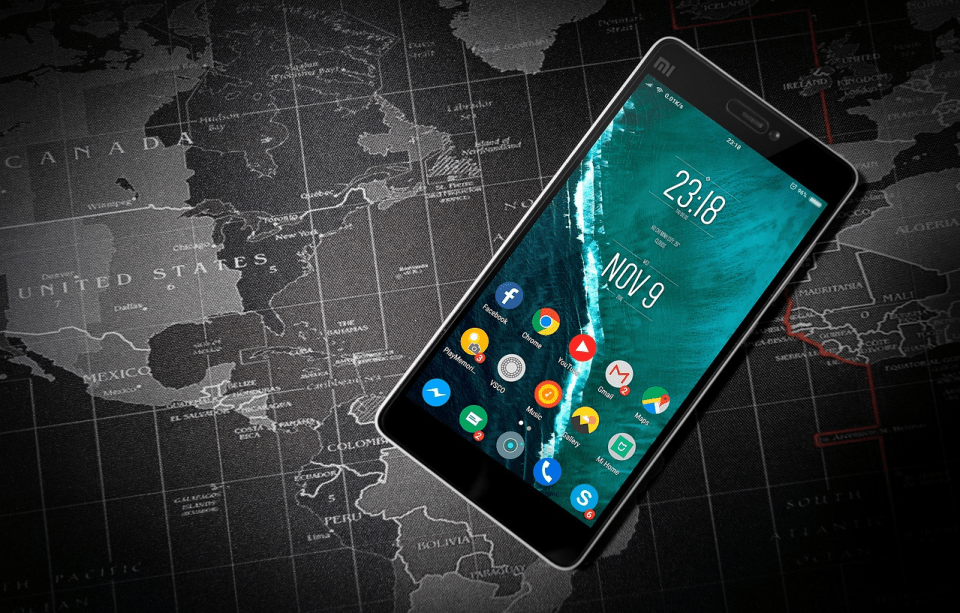Hidden gems of europe: 10 underrated cities that will steal your heart A smartphone displaying popular travel and communication apps lies on top of a world map, symbolizing digital tools and global connectivity for travelers exploring hidden gems of europe.