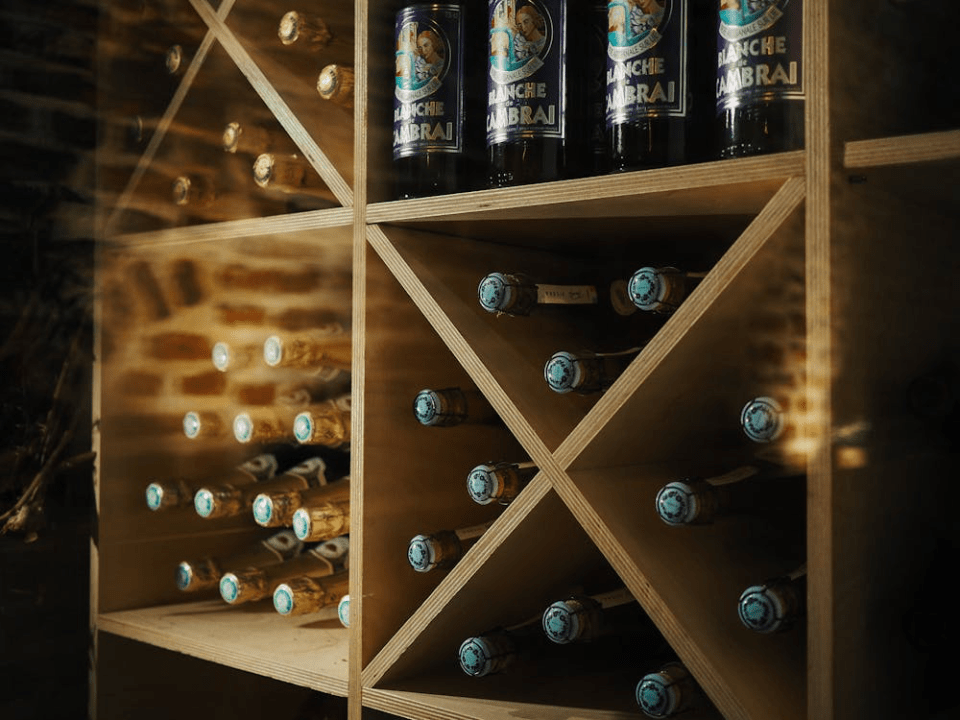 How to create a home wine cellar Wooden wine rack with crisscross shelving and bottle storage for a story on how to create a home wine cellar